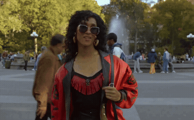 Woman In Sunglasses And Red Jacket In Park GIF