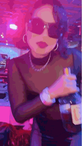 Woman In Sunglasses And Turtleneck Holding Alcohol GIF