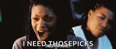 Woman In Sunglasses And Wig Smiling At Another Woman GIF