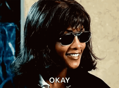 Woman In Sunglasses And Wig Smiling Saying Okay GIF