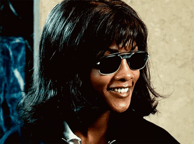 Woman In Sunglasses And Wig Smiling GIF