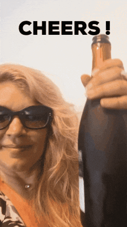 Woman in Sunglasses Holding Wine Bottle Cheers