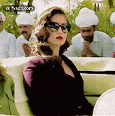 Woman In Sunglasses In Car With Men In Turbans GIF