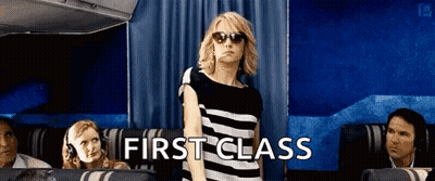 Woman In Sunglasses In First Class Airplane Seat GIF