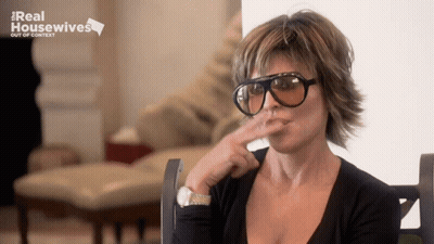 Woman In Sunglasses In Front Of Real Housewives Sign GIF