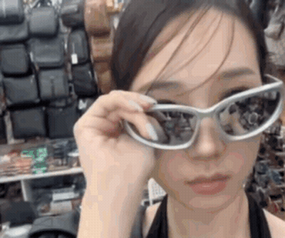Woman In Sunglasses Looking At Camera GIF