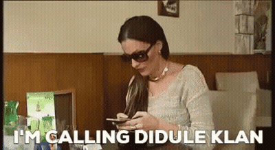Woman In Sunglasses Looking At Phone Saying I'm Calling Dibule Klan GIF
