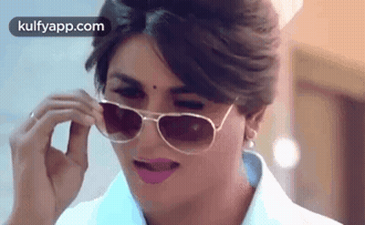Woman In Sunglasses Making A Face GIF