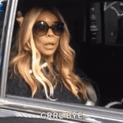Woman In Sunglasses Mouth Open In Car GIF