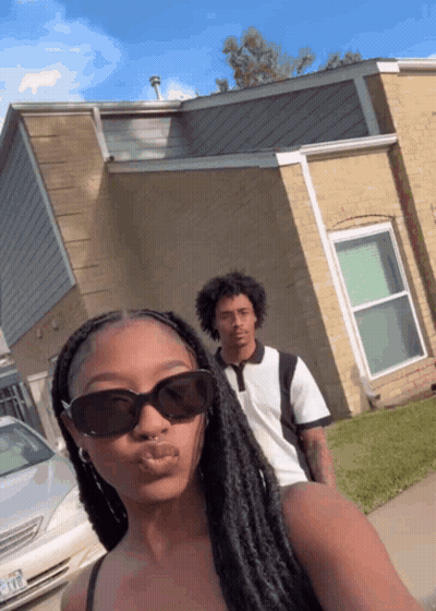 Woman In Sunglasses Next To Man And House GIF