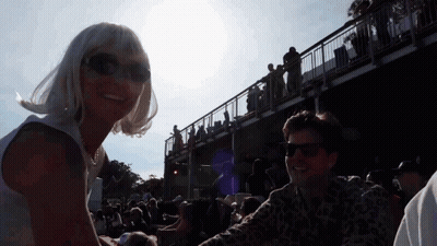 Woman In Sunglasses Next To Man In Crowd GIF