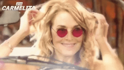 Woman In Sunglasses Smiling In Car GIF
