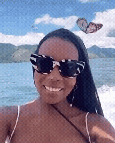 Woman In Sunglasses Taking Selfie On Boat With Butterflies GIF