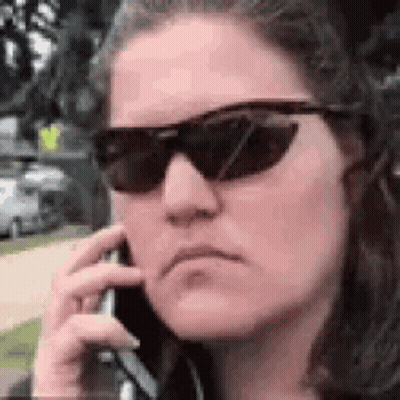 Woman In Sunglasses Talking On Cell Phone GIF