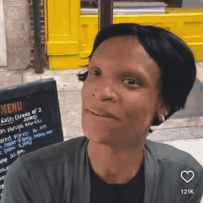 Woman In Sunglasses With Mouth Open In Car GIF