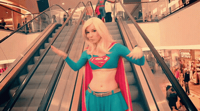 Woman In Supergirl Costume On Escalator GIF