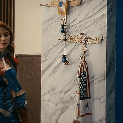 Woman In Superhero Costume In Front Of Wall With Eagles And LA Towel GIF