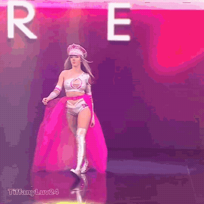 Woman in Superhero Costume Walking in Front of Letter R