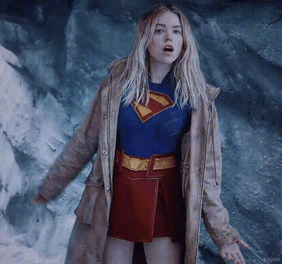 Woman In Superman Costume And Trench Coat GIF