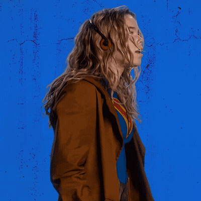 Woman In Superman Costume Blue Wall GIF