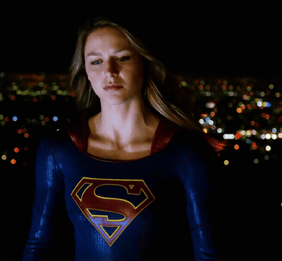 Woman In Superman Costume In City At Night GIF