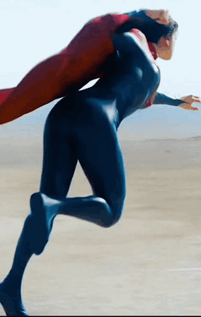 Woman In Superman Costume Running On Beach GIF