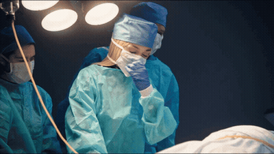 Woman In Surgical Gown Covering Face GIF