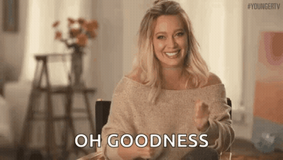Woman In Sweater Sitting In Chair Thumbs Up GIF
