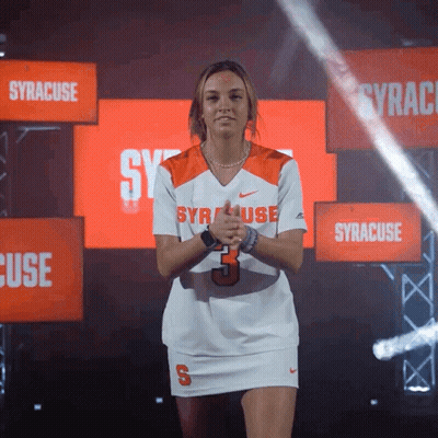 Woman In Syracuse Jersey In Front Of Syracuse Signs GIF