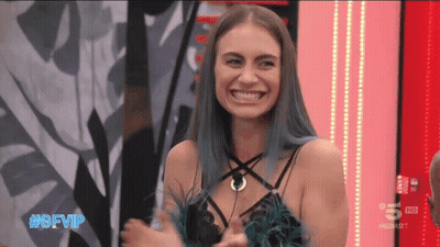 Woman In Tan Coat Speaking Into CBS Microphone GIF