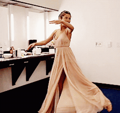 Woman In Tan Dress Dancing GIF