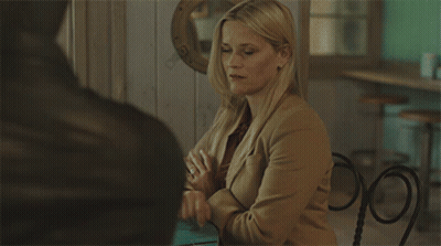 Woman In Tan Jacket Sitting At Table GIF