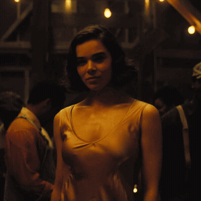 Woman In Tan Tank Top In Crowd GIF