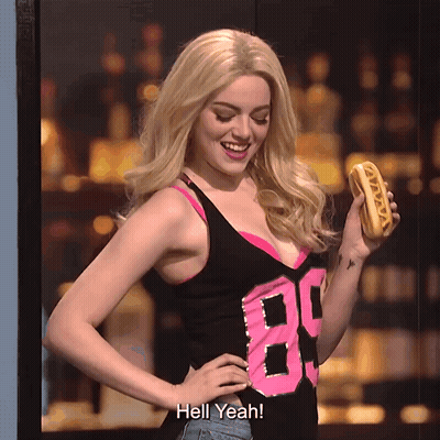 Woman in Tank Top 89 Holding Hot Dog