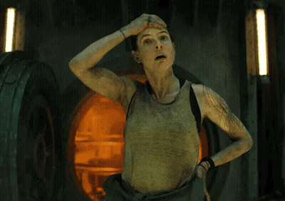 Woman In Tank Top Hand On Head In Dark Room GIF