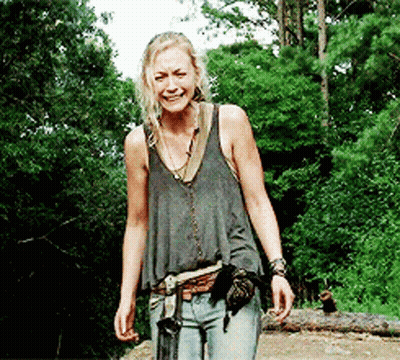 Woman In Tank Top Walking Through Woods GIF
