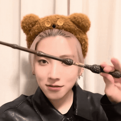 Woman In Teddy Bear Headband Holding Wand GIF