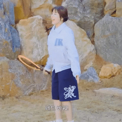 Woman In Teddy Jamming Jacket And Shorts By Rocks GIF
