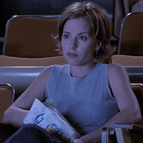 Woman In Theater Holding Popcorn GIF