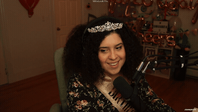 Woman In Tiara And Bride Sash Smiling At Microphone GIF