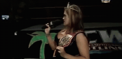 Woman In Tiara Holding Microphone And Pointing GIF