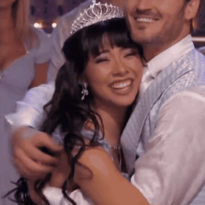 Woman In Tiara Hugged By Man GIF