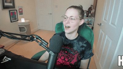 Woman In Tie Dye Shirt Sitting At Microphone GIF