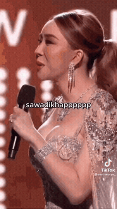 Woman In Tight Dress Singing Into Microphone GIF