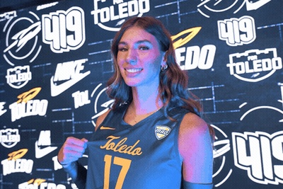Woman In Toledo Jersey Stands Before Wall GIF