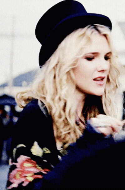 Woman In Top Hat And Floral Shirt GIF
