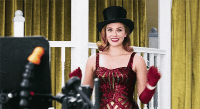 Woman In Top Hat And Red Gloves Smiling GIF