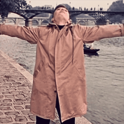 Woman In Trench Coat By River GIF