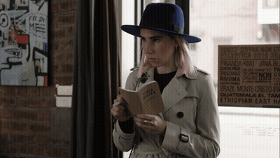 Woman In Trench Coat Reading Field Notes GIF