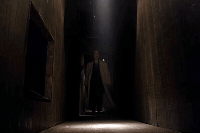 Woman In Trench Coat Standing By Lying Man GIF